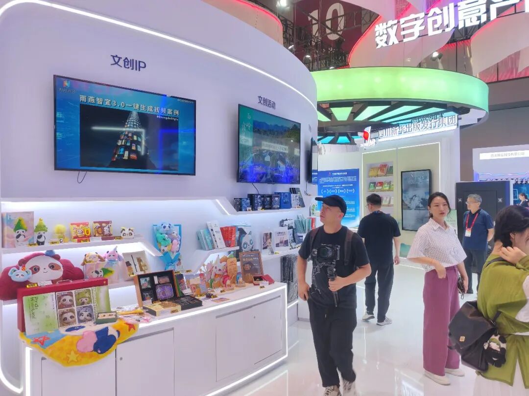 深圳文博会现场，观众正在成都传媒集团文创IP展区前驻足观看，背景电视上清晰显示“雨燕智室3.0一键生成视频案例”的AI演示画面，展台上摆满了丰富的文创周边。